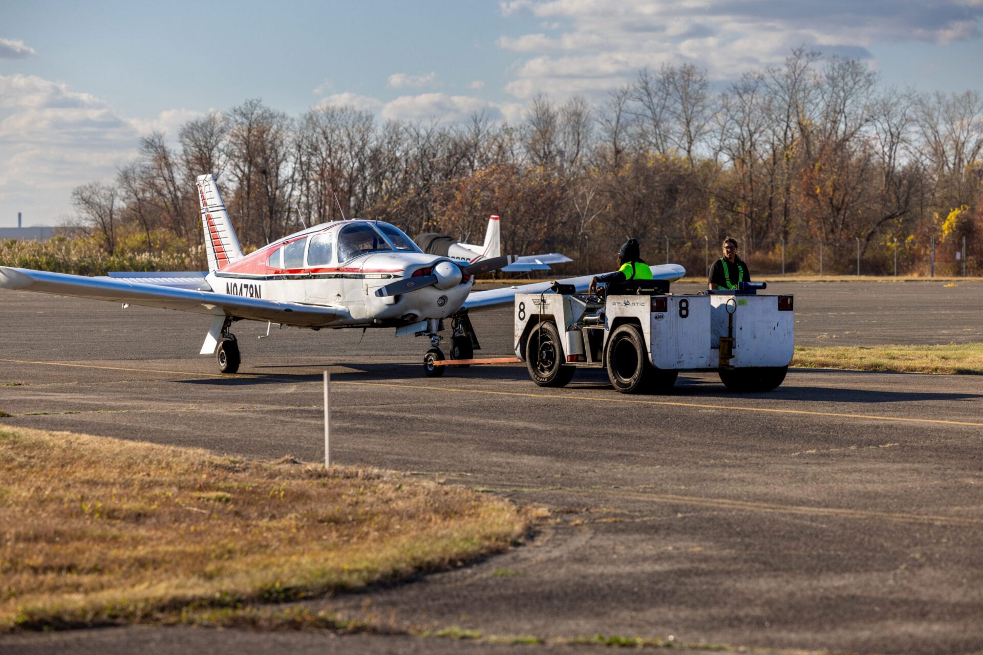 Small plane being towed on runway.