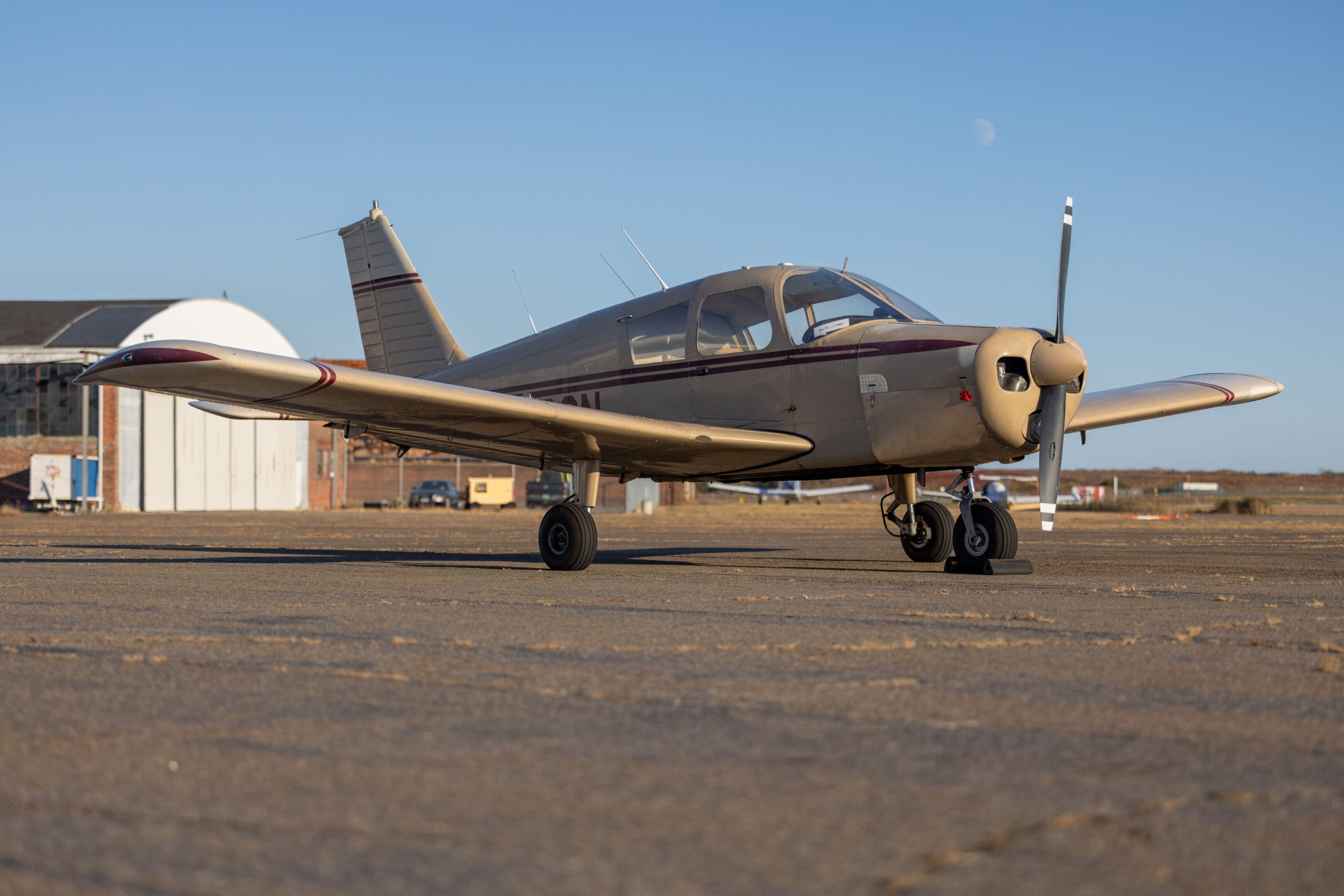 Small airplane parked on airport tarmac.