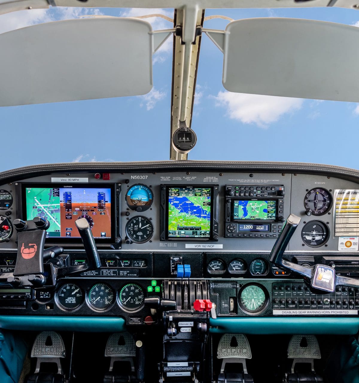 Small aircraft cockpit with digital displays.